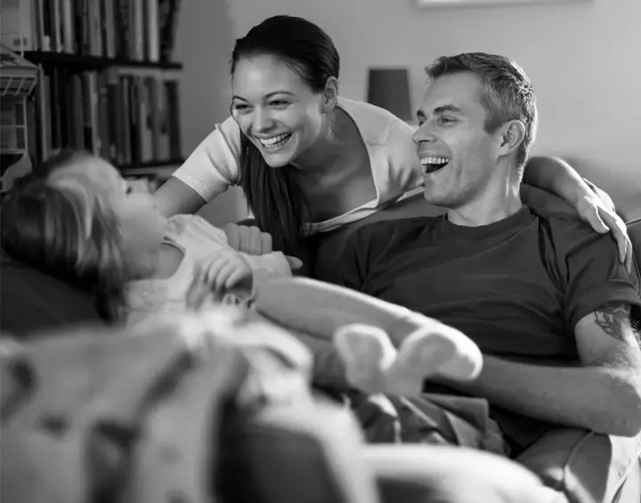 Couple laughing with child