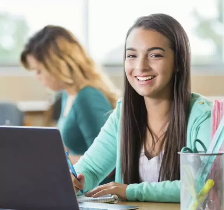 High school student working at a laptop